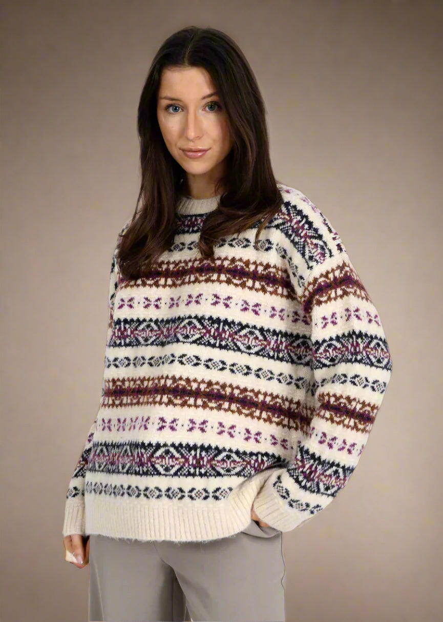 Woman wearing a patterned sweater on a white background
